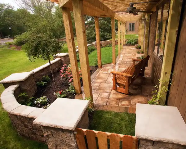 covered stone patio with a curved seat wall